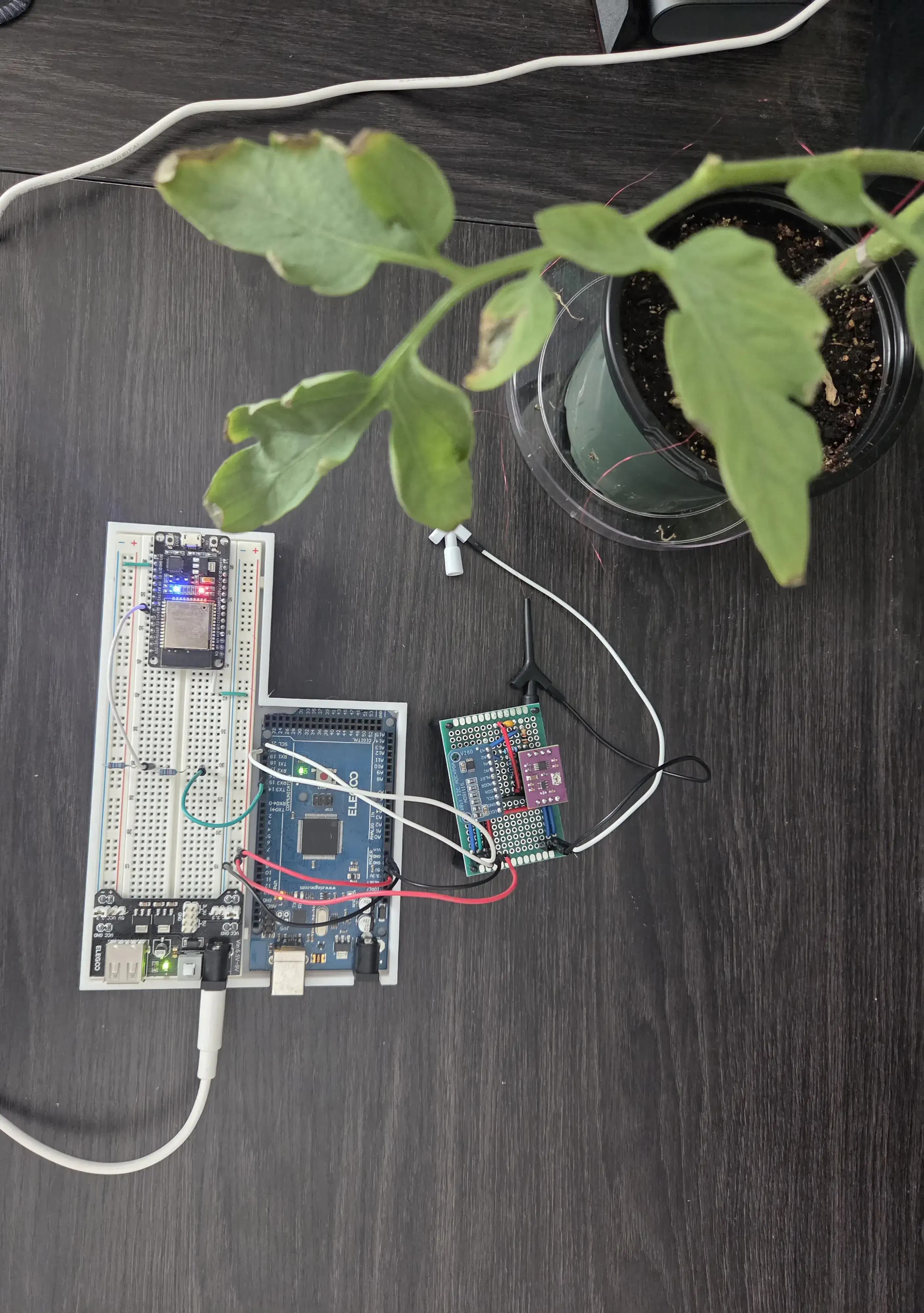Picture of electronics with breadboard, Arduino, ESP32, and force-sensitive resistors.